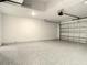 Clean and spacious two car garage with epoxy floors, garage door and white concrete block walls at 2675 Ridgetop Ln, Clermont, FL 34711