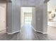 View of the hall with wood-look tile connecting to kitchen and backyard at 2675 Ridgetop Ln, Clermont, FL 34711