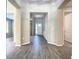 Hallway featuring gray wood-look tile and a view of the front door at 2675 Ridgetop Ln, Clermont, FL 34711