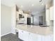 Open concept kitchen featuring an island, stainless appliances, white cabinets, and tile flooring at 2675 Ridgetop Ln, Clermont, FL 34711