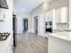 Modern kitchen featuring stainless steel appliances, white cabinetry, and tile flooring at 2675 Ridgetop Ln, Clermont, FL 34711