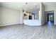 Open-concept kitchen with white cabinetry, stainless steel appliances, and wood-look tile flooring at 2675 Ridgetop Ln, Clermont, FL 34711