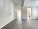 Spacious living room with wood-look tile flooring, neutral paint, and open floor plan at 2675 Ridgetop Ln, Clermont, FL 34711