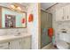 Functional bathroom featuring a vanity sink, shower, and floral wallpaper at 3026 Myakka River Rd, Tavares, FL 32778
