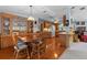 The open dining area is complete with hardwood floors and views into the kitchen at 3026 Myakka River Rd, Tavares, FL 32778