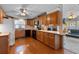 Charming kitchen boasts a full suite of appliances, ample cabinet space, and hardwood flooring at 3026 Myakka River Rd, Tavares, FL 32778
