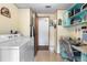 Laundry room with washer, dryer, and built-in desk and shelving at 3026 Myakka River Rd, Tavares, FL 32778
