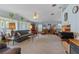 Comfortable living room with cozy seating, large windows, and an open layout to the dining area at 3026 Myakka River Rd, Tavares, FL 32778