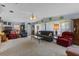Spacious living room offers comfortable seating, neutral decor, and plush carpeting at 3026 Myakka River Rd, Tavares, FL 32778