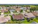 A serene neighborhood with well-kept homes and greenery, featuring screened-in patios and mature trees at 3041 Batally Ct, The Villages, FL 32162