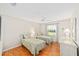 Bedroom with two twin beds, ceiling fan, and bright window views at 3041 Batally Ct, The Villages, FL 32162