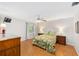 Cozy bedroom features hardwood floors, a ceiling fan, and two matching bedside tables at 3041 Batally Ct, The Villages, FL 32162