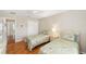 Bright bedroom featuring twin beds, hardwood floors, and a large window at 3041 Batally Ct, The Villages, FL 32162