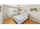 Bedroom featuring a full bed, hardwood floors, bright window, and natural lighting at 3041 Batally Ct, The Villages, FL 32162