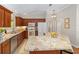 Kitchen features granite countertops, stainless steel appliances, and a center island, perfect for cooking at 3041 Batally Ct, The Villages, FL 32162