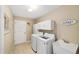 Well-lit laundry room with modern washer and dryer and ample storage space at 3041 Batally Ct, The Villages, FL 32162