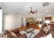Cozy living room with hardwood floors, an open layout to dining, and views into the kitchen at 3041 Batally Ct, The Villages, FL 32162