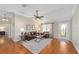 Comfortable living room with hardwood floors, ceiling fan, and natural light, and a glass-panelled exterior door at 3041 Batally Ct, The Villages, FL 32162