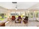 Well-lit sunroom with tiled flooring, multiple armchairs, and several bright, large windows at 3041 Batally Ct, The Villages, FL 32162