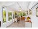 Sunroom featuring tile floors, large windows, natural light, and a ceiling fan at 3041 Batally Ct, The Villages, FL 32162