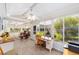 Spacious sunroom with tile floors, abundant light, and views of the beautiful backyard at 3041 Batally Ct, The Villages, FL 32162
