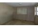 Bedroom with vertical panel walls and window with blinds at 323 Hawthorne Blvd, Leesburg, FL 34748