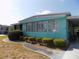 Front exterior of home featuring shrubbery and a walkway at 323 Hawthorne Blvd, Leesburg, FL 34748