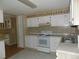 Classic kitchen featuring white cabinets and a standard appliance package at 323 Hawthorne Blvd, Leesburg, FL 34748