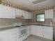 Functional kitchen with ample counter space, perfect for culinary enthusiasts at 323 Hawthorne Blvd, Leesburg, FL 34748