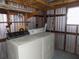 Laundry room with washer, dryer, overhead shelf, and shelving at 323 Hawthorne Blvd, Leesburg, FL 34748