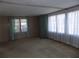 Bright living room featuring large windows offering plenty of natural light at 323 Hawthorne Blvd, Leesburg, FL 34748