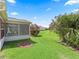 Lush backyard featuring well-maintained lawn and bright pink Oleander bushes creating a peaceful retreat at 3266 Woodridge Dr, The Villages, FL 32162