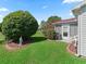 Beautiful backyard with lush green grass, lovely statue and privacy bushes creating a serene outdoor space at 3266 Woodridge Dr, The Villages, FL 32162
