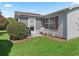 Green backyard with a patio area, perfect for outdoor entertaining at 3266 Woodridge Dr, The Villages, FL 32162
