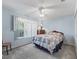 Cozy bedroom with a large window, light blue walls, and comfortable carpet at 3266 Woodridge Dr, The Villages, FL 32162