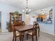 Traditional dining room complemented by a china cabinet and views of the adjacent kitchen and living room at 3266 Woodridge Dr, The Villages, FL 32162