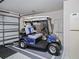 A Golf Cart sits on an epoxy floor inside a garage with ample space at 3266 Woodridge Dr, The Villages, FL 32162