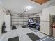 Spacious garage with epoxy flooring, a golf cart, and extra storage space at 3266 Woodridge Dr, The Villages, FL 32162