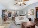 Open-concept living room featuring views of the dining area and kitchen, enhanced by natural light at 3266 Woodridge Dr, The Villages, FL 32162