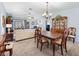 Bright living room flowing into the dining area, featuring sliding doors, and neutral decor at 3266 Woodridge Dr, The Villages, FL 32162