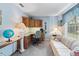 Home office with built-in desk, cabinets, and natural light at 3266 Woodridge Dr, The Villages, FL 32162