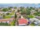 Aerial view captures peaceful suburban neighborhood on a tranquil lake with boat docks, enhancing its appeal for waterfront living at 33620 Picciola Dr, Fruitland Park, FL 34731