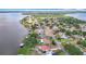 Captivating aerial perspective showcasing waterfront homes, docks, and the expansive lake, perfect for lakeside living at 33620 Picciola Dr, Fruitland Park, FL 34731