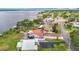 Aerial view captures serene homes along a tranquil lake showcasing boat docks and waterfront living, highlighting recreational opportunities at 33620 Picciola Dr, Fruitland Park, FL 34731