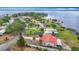 A lakefront view features a tile roof home with palm trees and a private dock at 33620 Picciola Dr, Fruitland Park, FL 34731