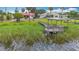 Aerial view of a home with a dock and boat lift to the lake provides serene lake access, ideal for relaxation and water activities at 33620 Picciola Dr, Fruitland Park, FL 34731