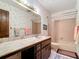 Bathroom featuring a large countertop, tub with shower, and neutral decor at 33620 Picciola Dr, Fruitland Park, FL 34731
