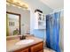 Bathroom featuring a vanity with granite counters, a storage cabinet, and shower with a plastic liner at 33620 Picciola Dr, Fruitland Park, FL 34731