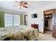 This bedroom features a ceiling fan, large window, and closet with built-in shelving at 33620 Picciola Dr, Fruitland Park, FL 34731