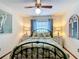 Relaxing bedroom featuring a tropical-themed bed, ceiling fan and decorative art at 33620 Picciola Dr, Fruitland Park, FL 34731